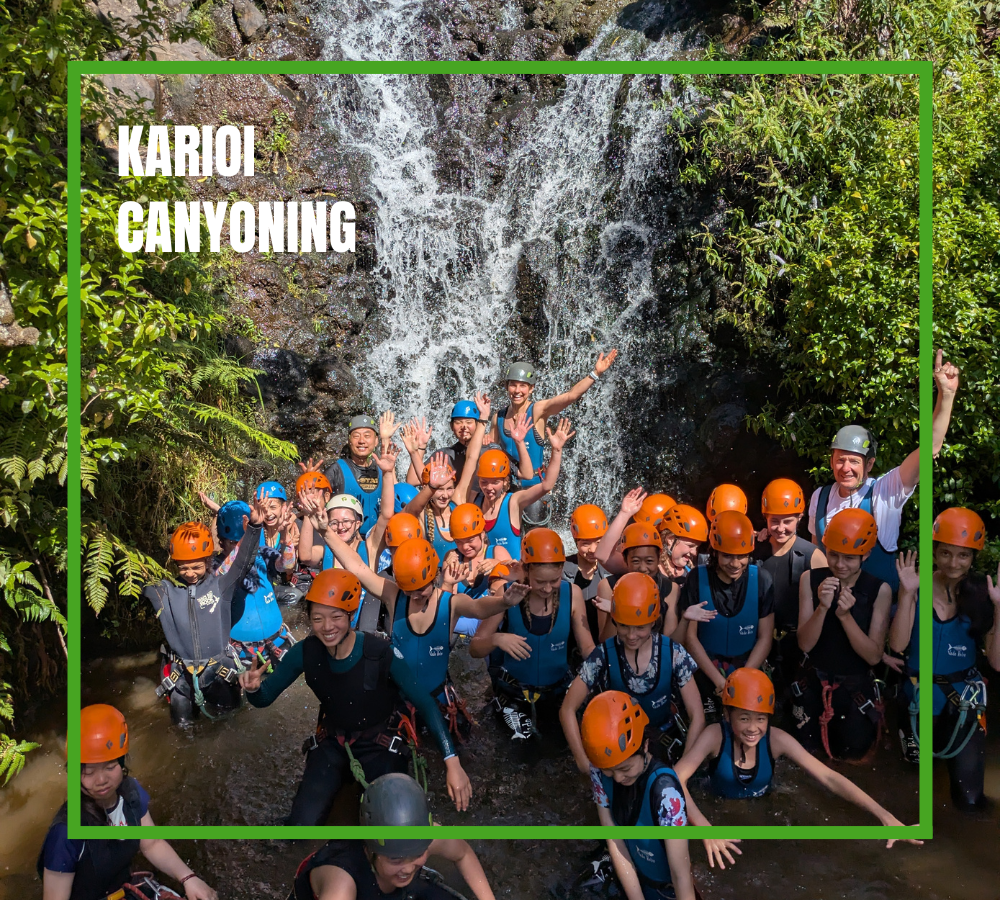 School Holiday Program Canyoning in front of waterfall