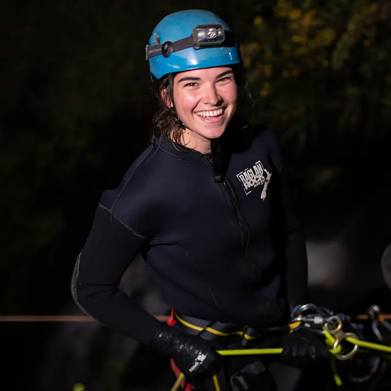 Smiling canyoner ready to abseil at night