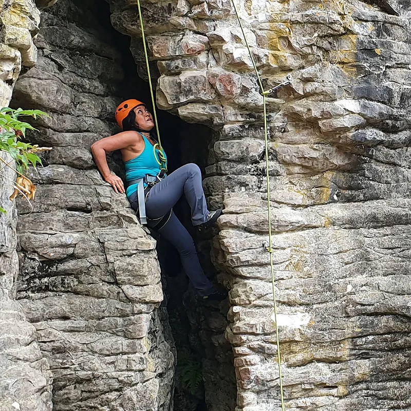 Climber top-rope climbing in a rock chimney near Raglan