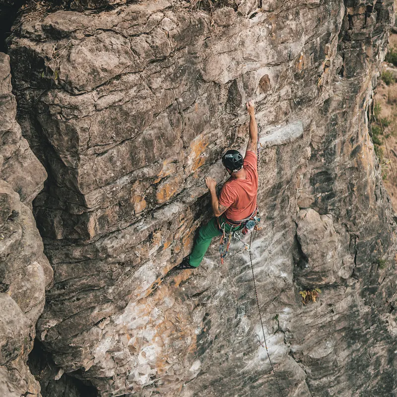 Climber leading a steep sport route on Raglan rock
